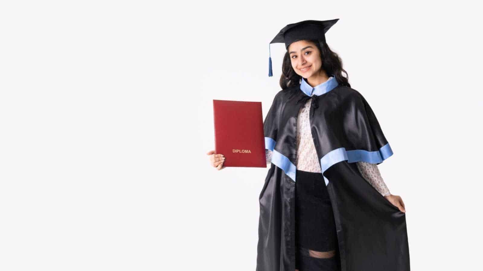 University graduate indian race woman wearing academic regalia and red diploma isolated.