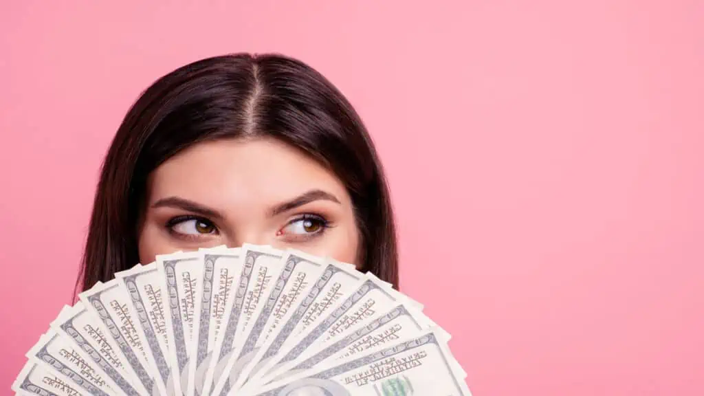 girl with money hiding face