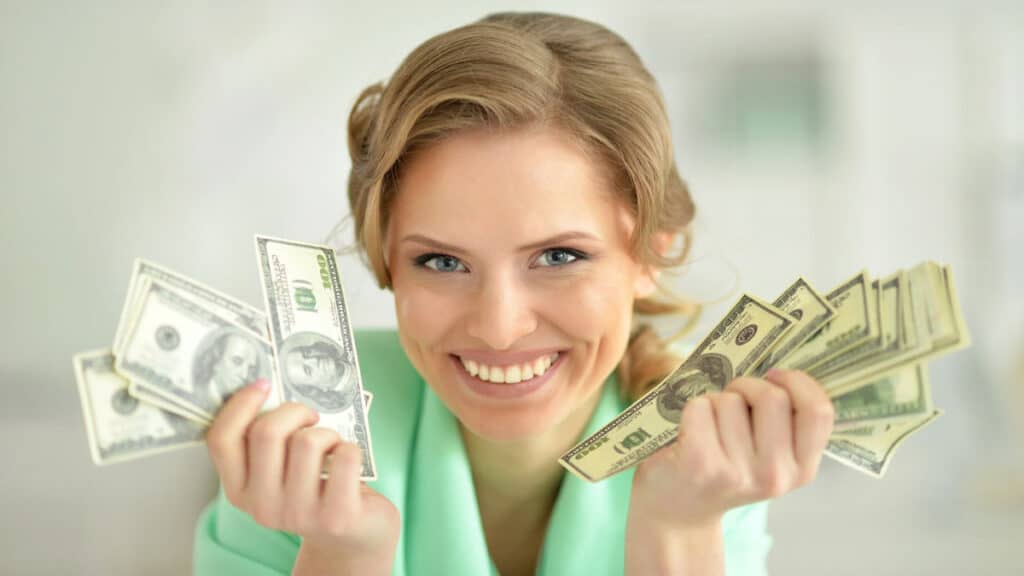 woman holding money in both hands