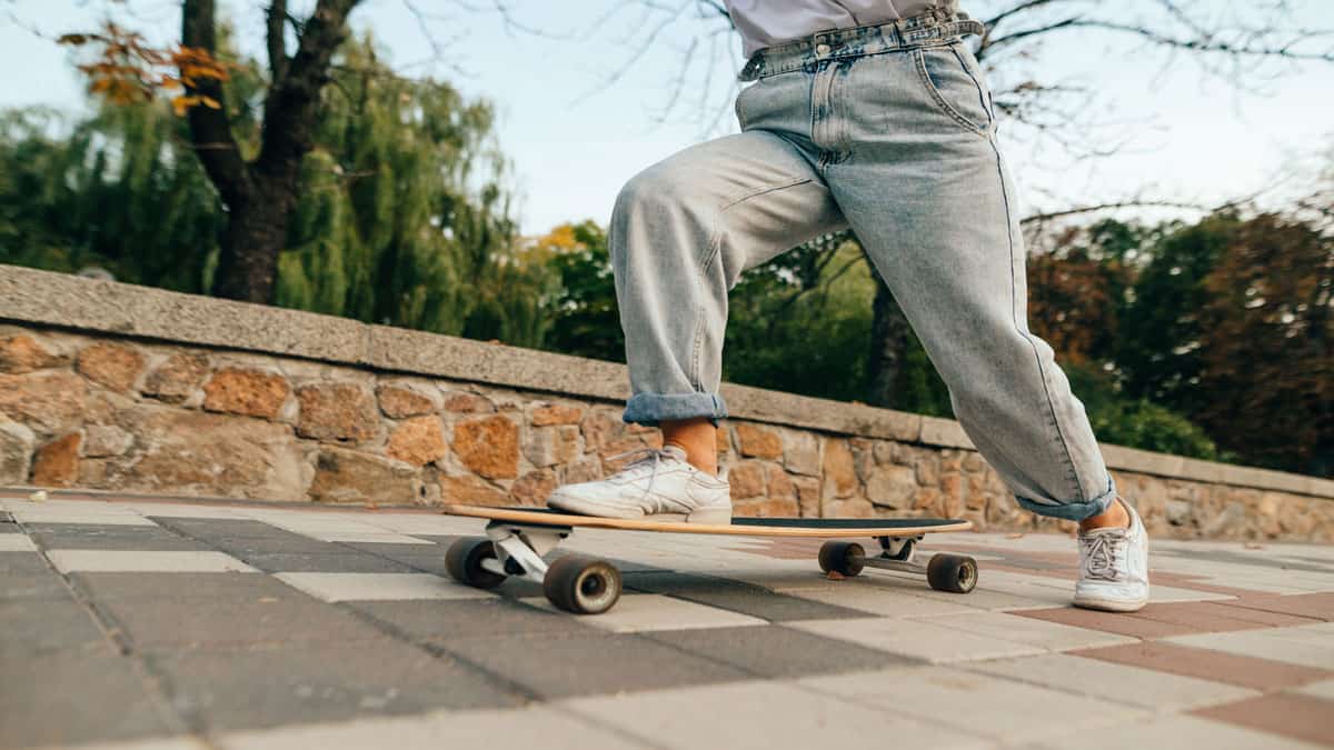 girl on skateboard wearing baggy jeans