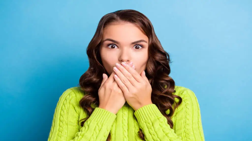 shocked woman covering mouth