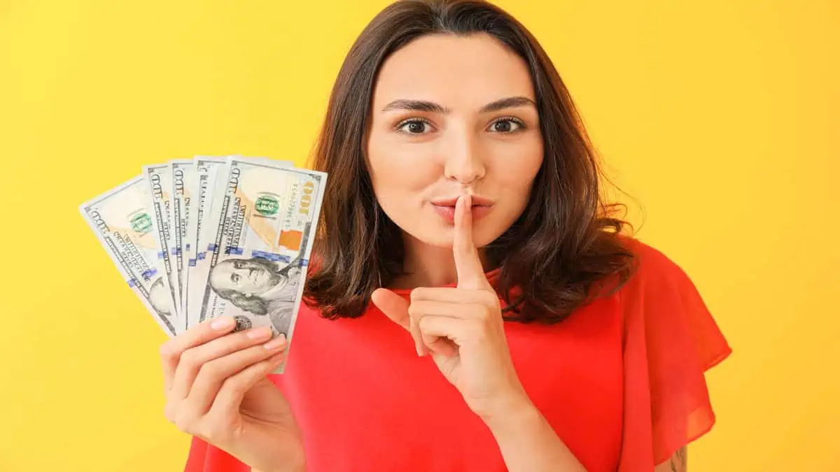 woman with money being quiet
