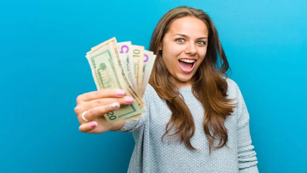 young woman holding cash