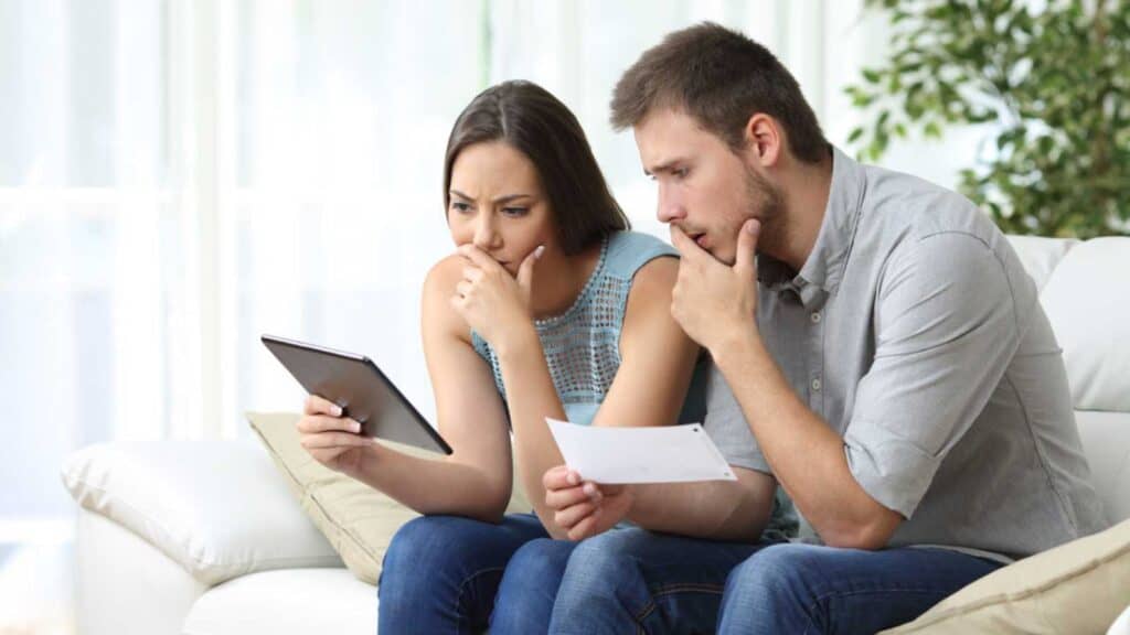Couples stressed looking at bills