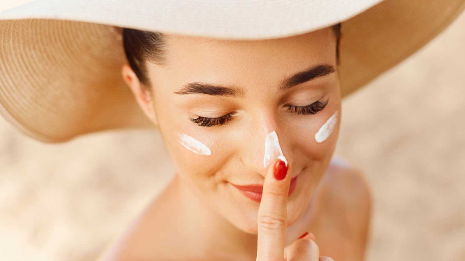 Woman using sunscreen