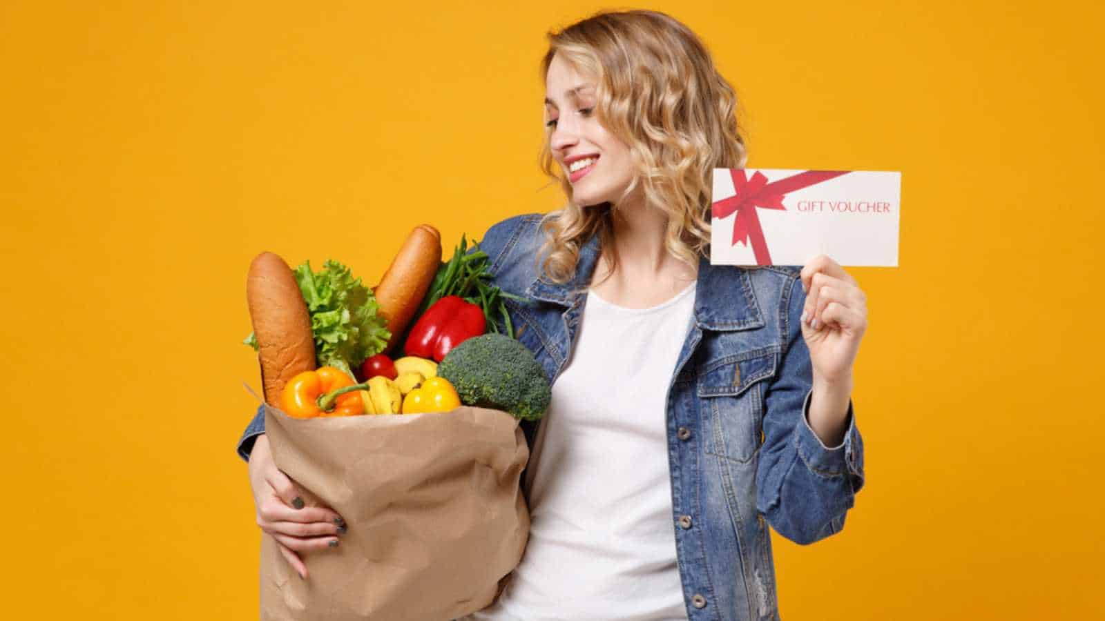 Woman with grocery and coupon