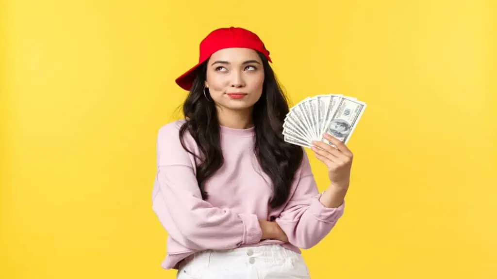 young-woman-holding-cash-with-hat
