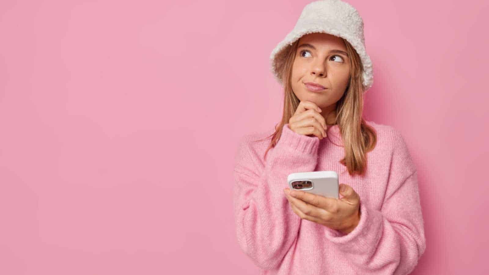 Young girl imagining with mobile in hands
