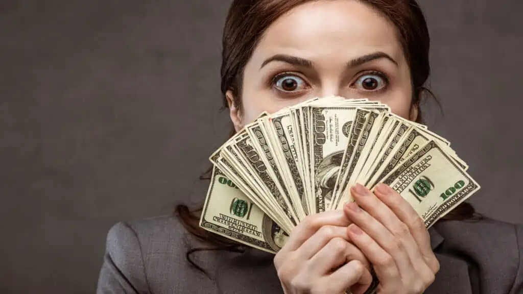 shocked woman with money