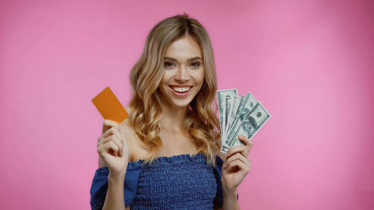 woman-holding-credit-card-and-cash
