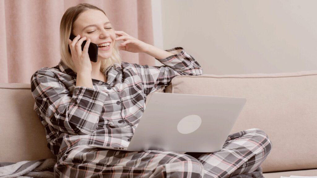 woman on couch wearing pajamas