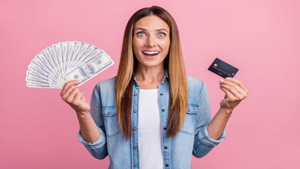 young woman with cash and credit card