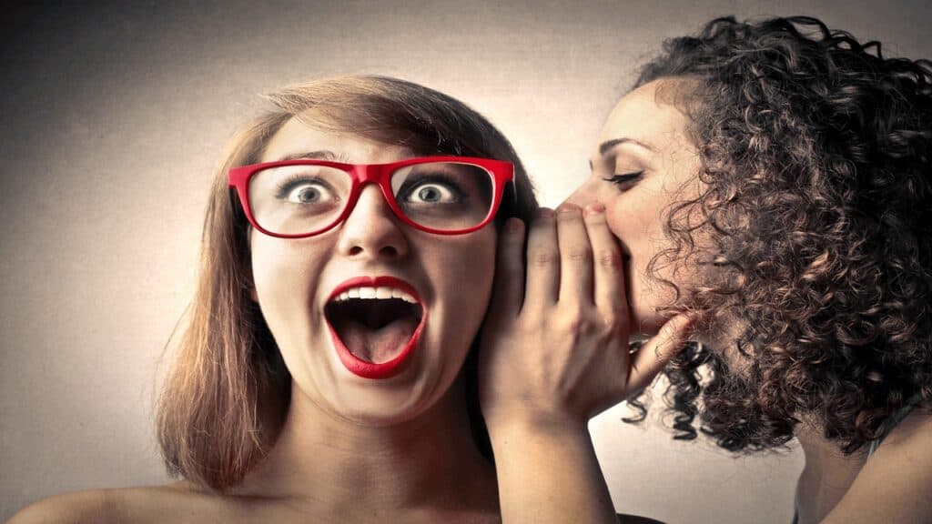 girls whispering secrets