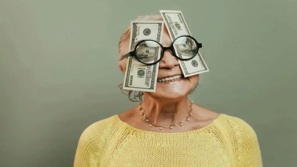 old lady with money on face