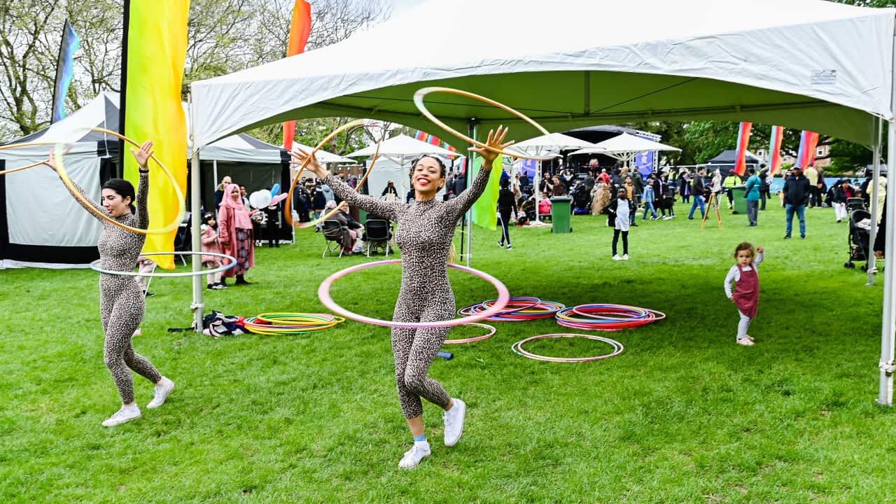 Women playing with hula hoop in festival