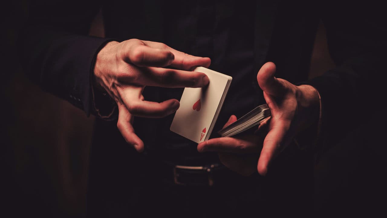 Magician- Man showing tricks with cards