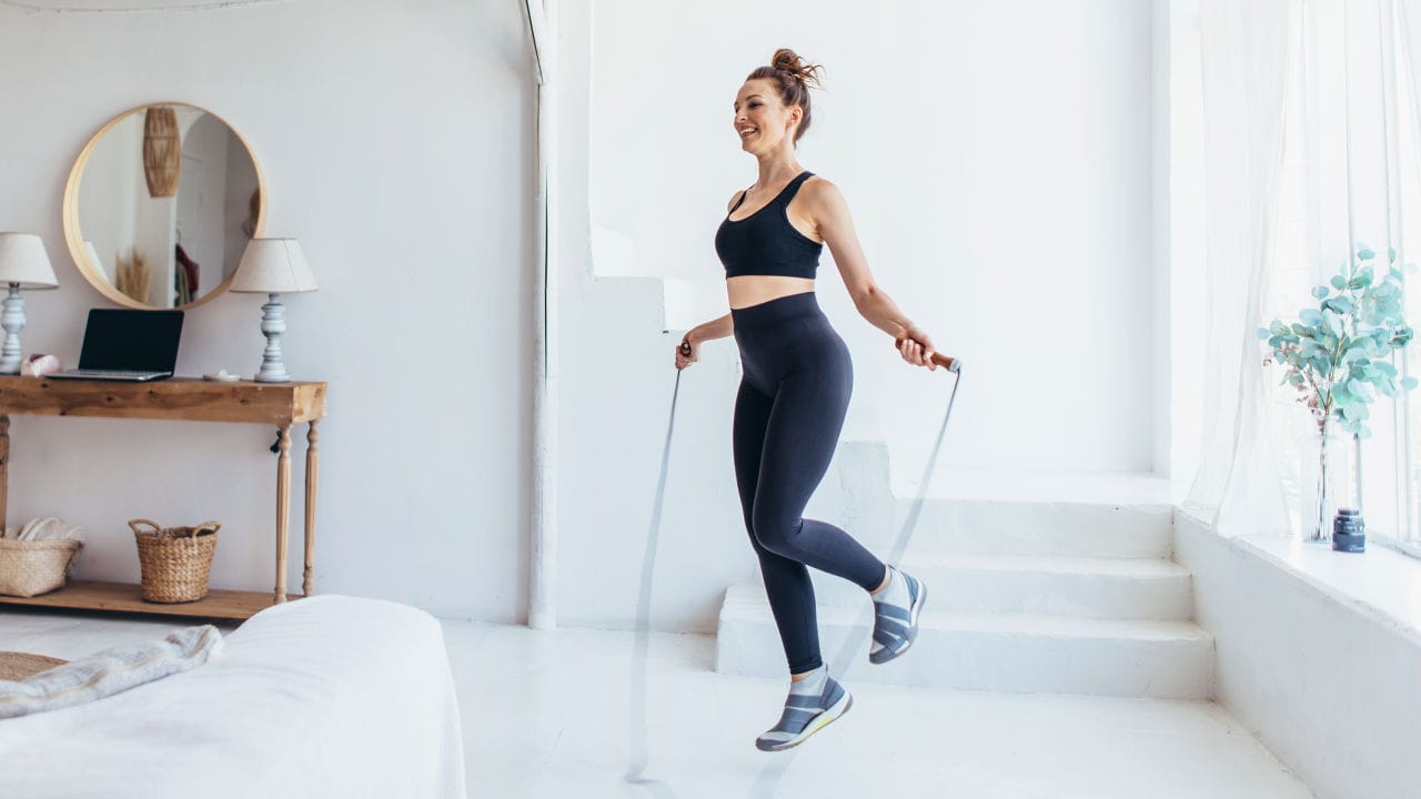lady using jump rope on house