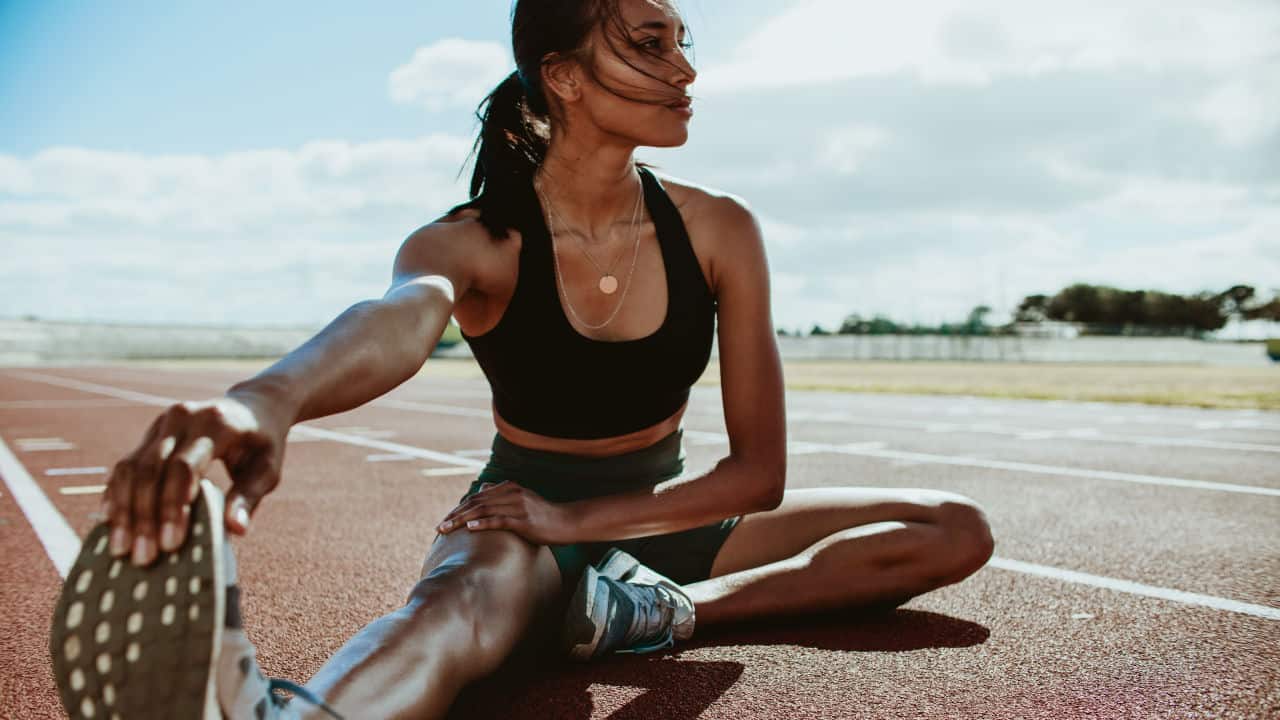 lady stretching on a track
