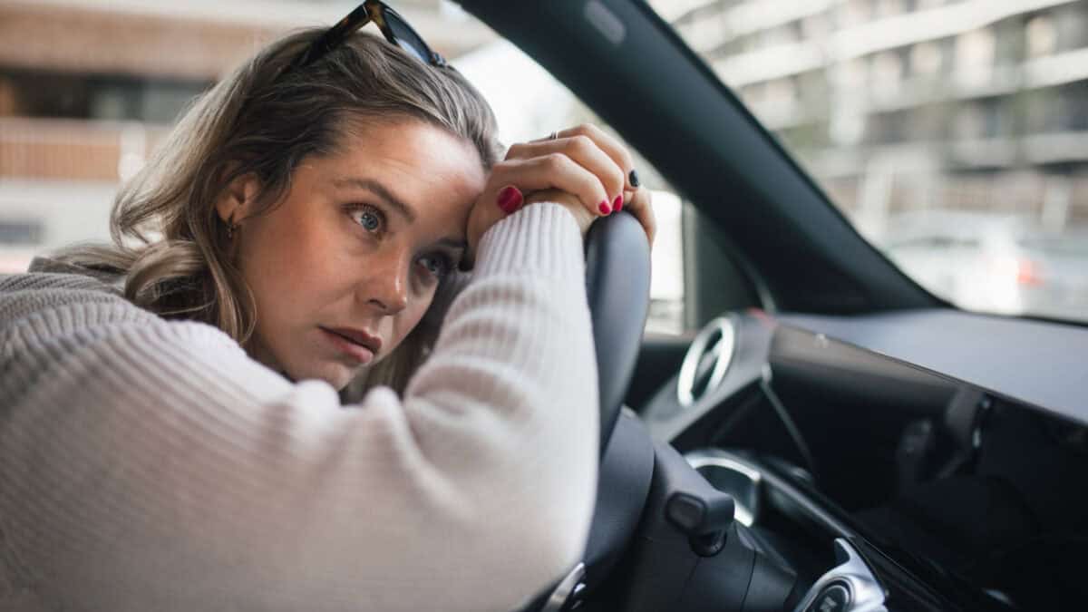 woman stressed and worried in the car