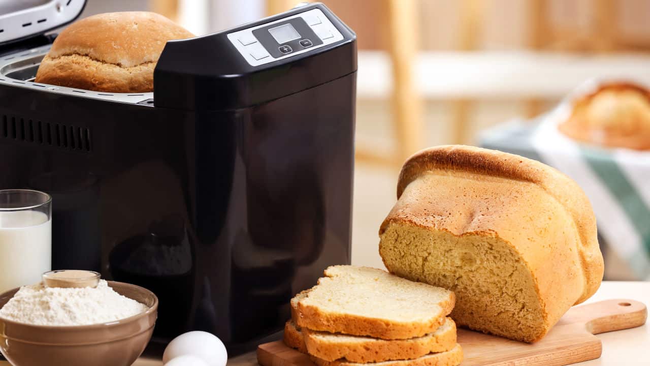 sliced loaf and bread machine on table