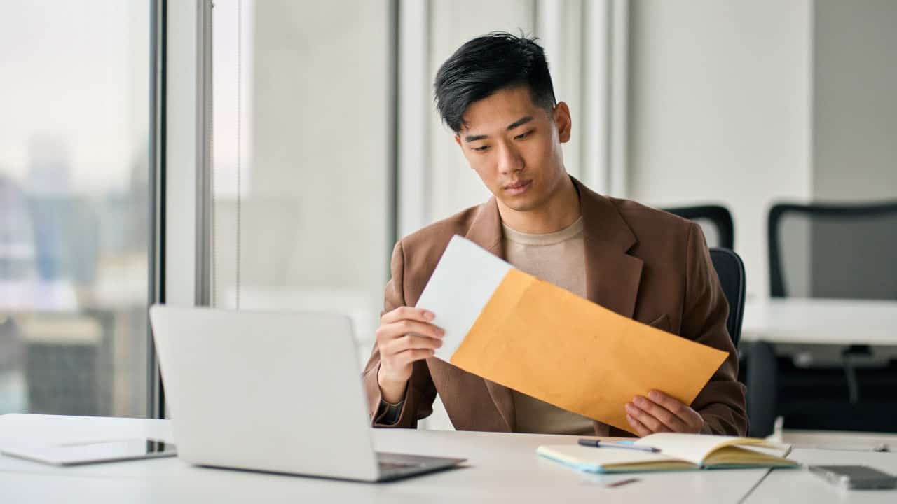 man with documents and laptop