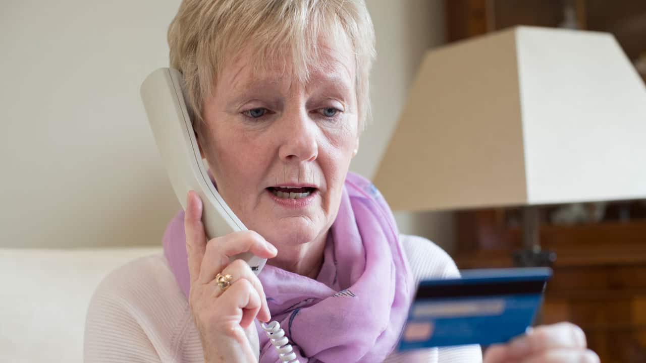 Woman Giving Credit Card Details On The Phone
