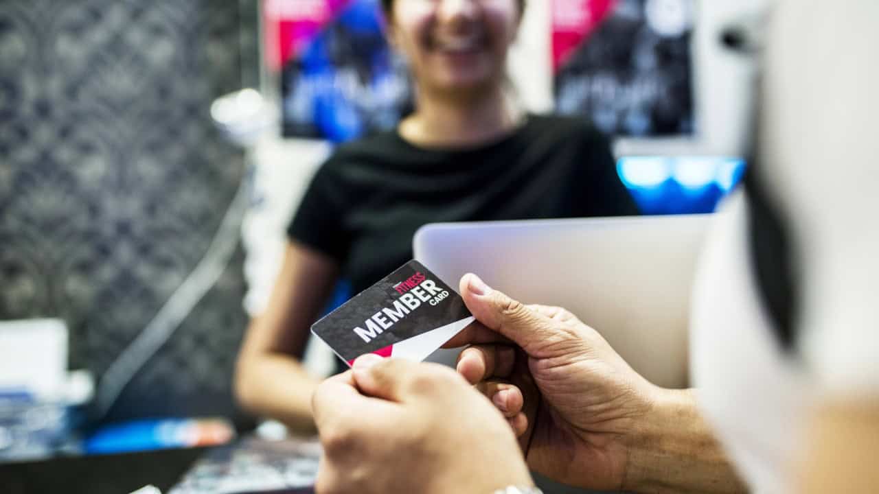 Fitness membership concept, man taking member card