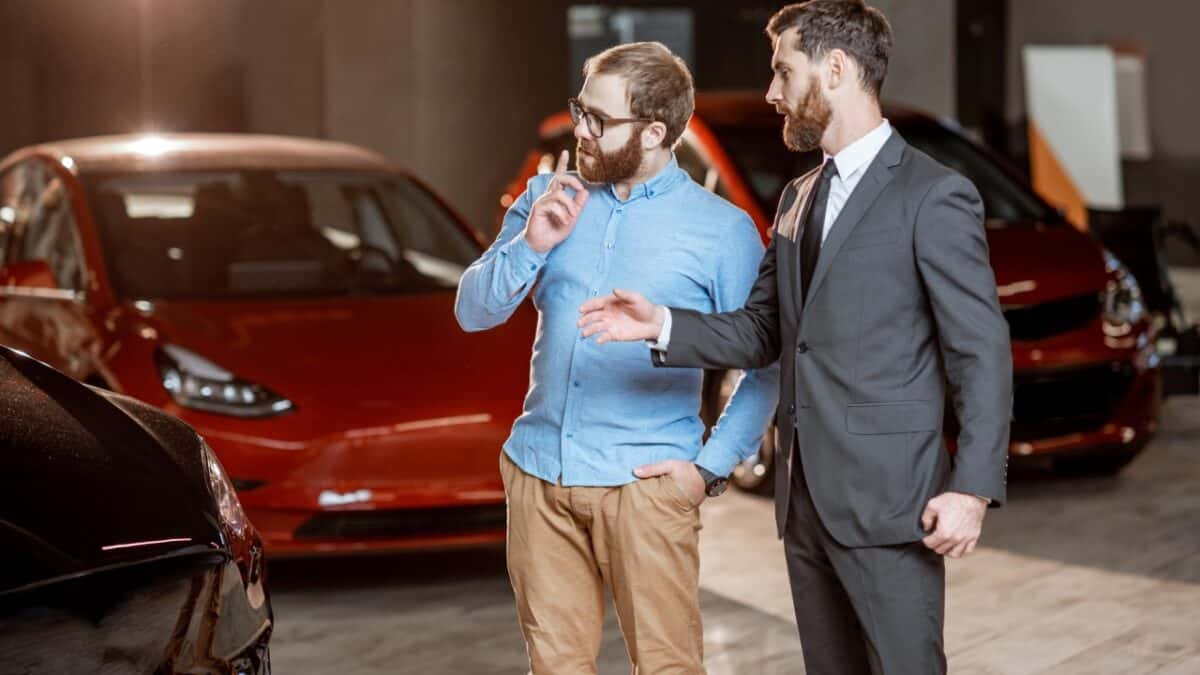 Client with a salesman at the showroom with electric cars