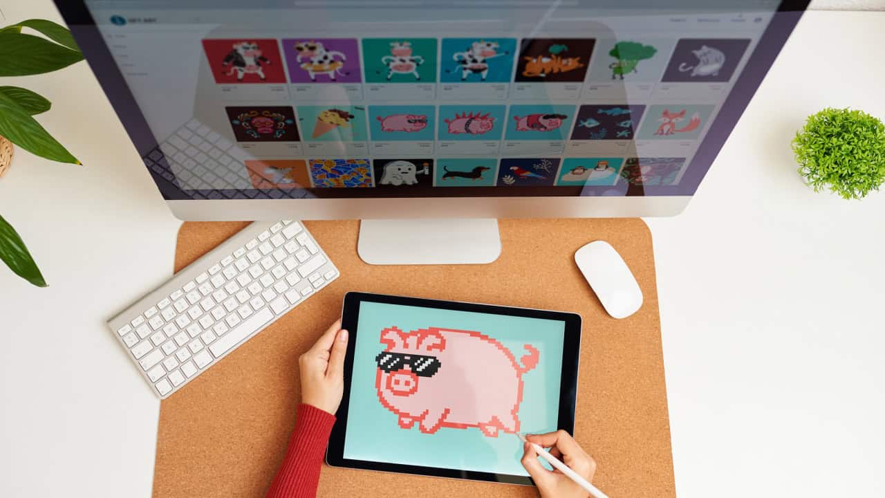 NFT artist painting on a digital tablet in his home office