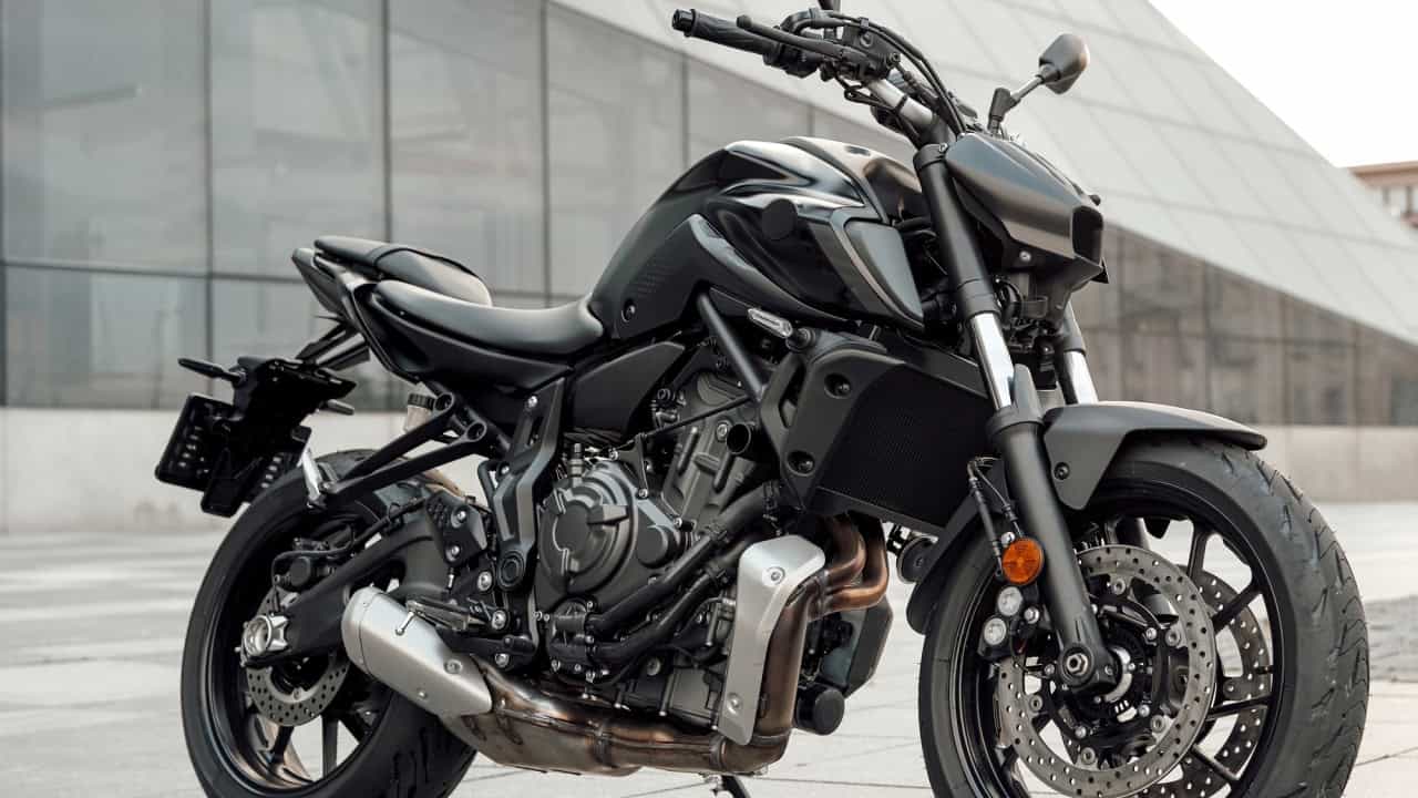 Custom black motorcycle parked outdoors in city in daytime